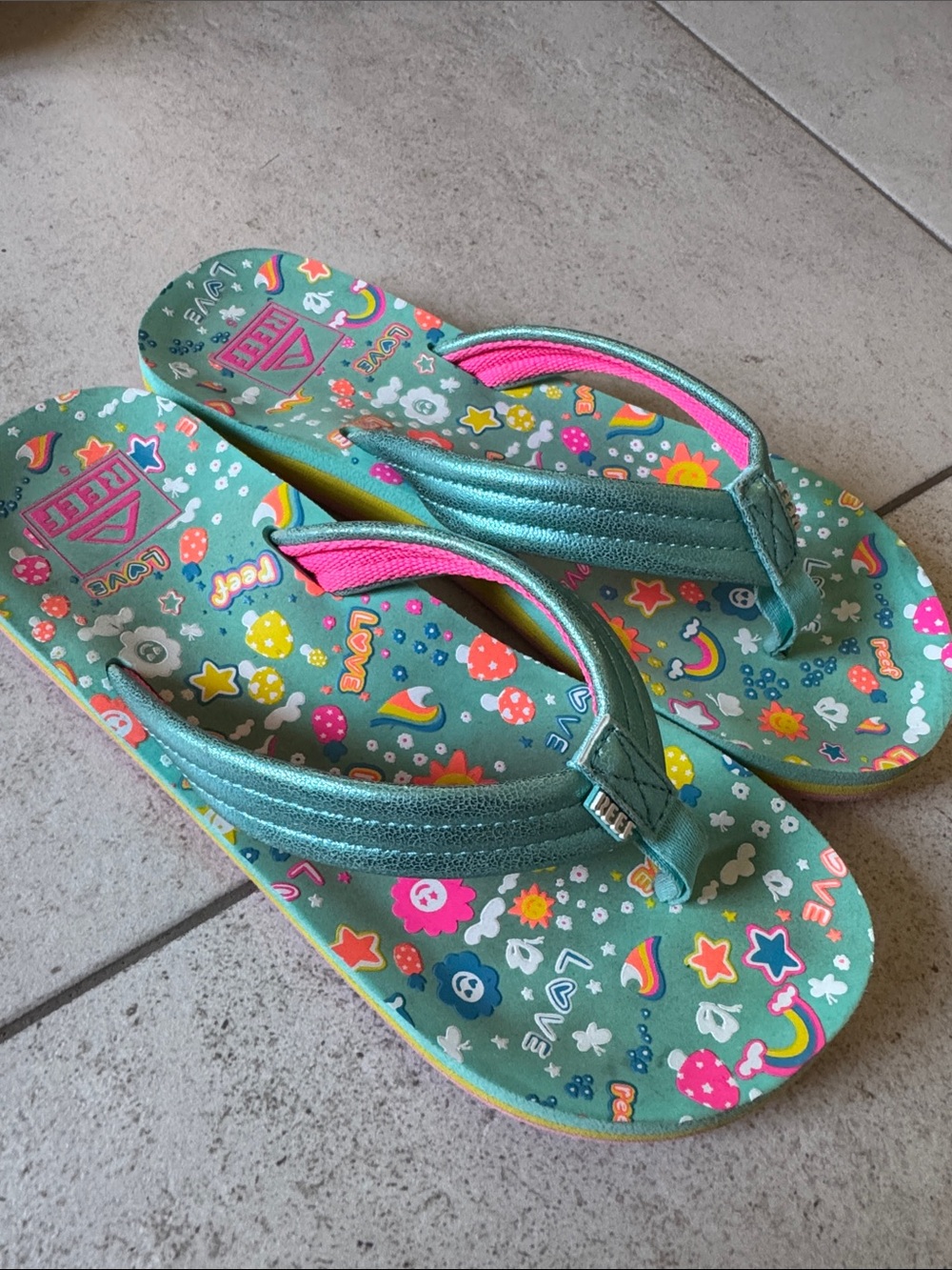 Reef Big Girls Teal Rainbow Print Flip Flops with Pink Accents